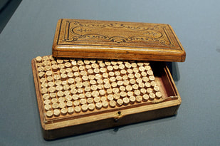wooden box holding homeopathic remedies in tiny vials